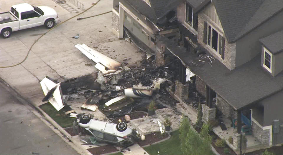 This frame from video shows the scene of a small plane that crashed into a house in Payson, Utah, on Monday, Aug 13, 2018. Authorities said the pilot was killed in the crash. (John Wilson/KSL-TV/Deseret News via AP)