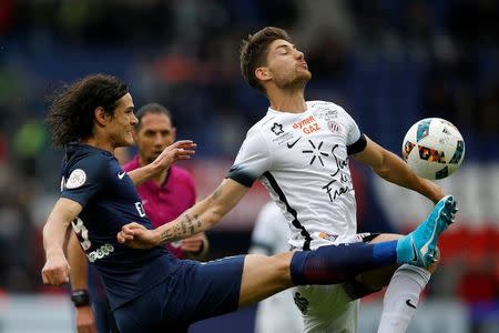 Football Soccer - Paris St Germain v Montpellier - French Ligue 1 - Parc des Princes, Paris, France - 22/4/17. Paris St Germain's Edinson Cavani and Montpellier's Paul Lasne in action. REUTERS/Stephane Mahe