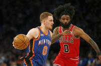 New York Knicks guard Donte DiVincenzo, left, dribbles past Chicago Bulls guard Coby White, right, during the first half of an NBA basketball game Sunday, April 14, 2024, in New York. (AP Photo/John Munson)