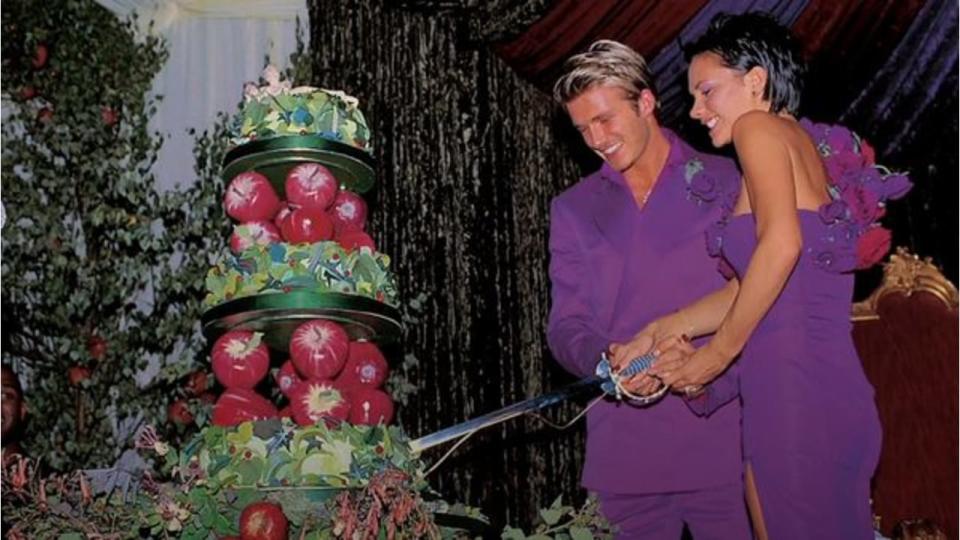 David and Victoria Beckham cutting their wedding cake