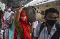 Travellers wait in queue to test for COVID-19 at a train station in Mumbai, India, Tuesday, Nov. 30, 2021. (AP Photo/Rafiq Maqbool)