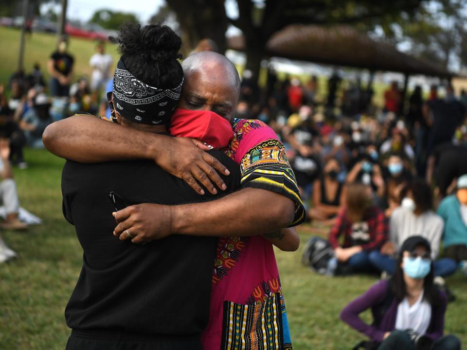 GARDENA, CALIFORNIA JUNE 20, 2020-Pastor James Thomas, right, is hugged after a speach at a Black Lives Matter Los Angeles rally to call for justice in the fatal shooting of KennethRoss Jr., who was shot by a Gardena police officer in 2018.