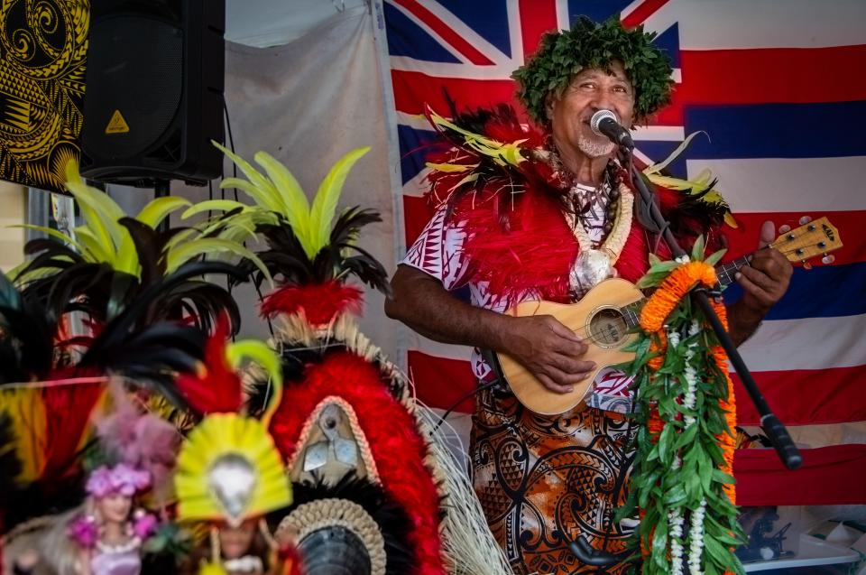 Tavita Taue'etia plays the ukulele at the Pacific islander village during CelebrAsian at the Western Gateway Park in Des Moines,  Friday, Oct. 1, 2021.