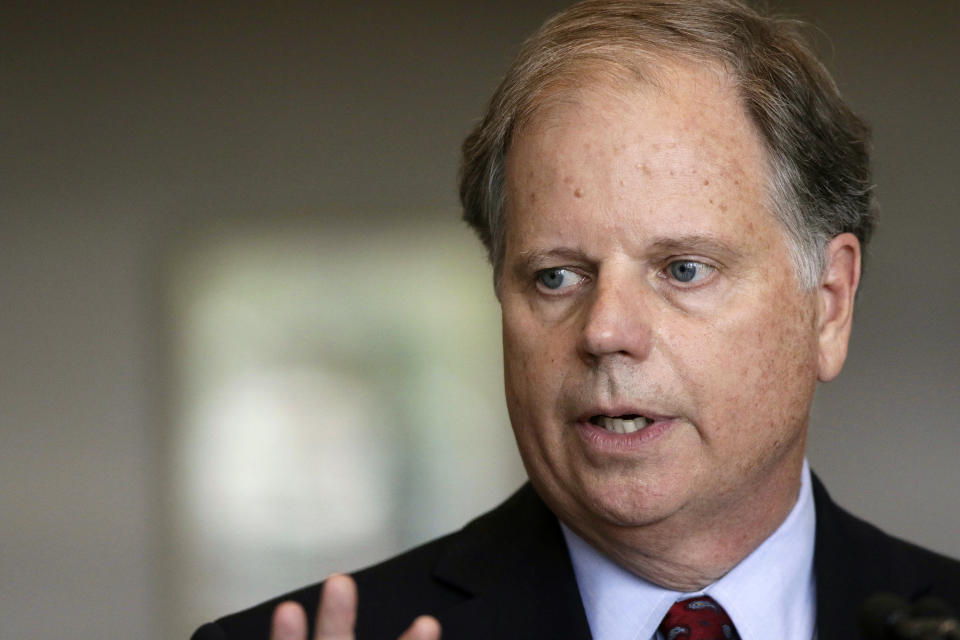 FILE - In this Friday, Sept. 7, 2018, file photo, Sen. Doug Jones, D-Ala., waits to speak at the dedication for the United States Courthouse for the Southern District of Alabama in Mobile, Ala. Alabama’s attorney general says his office is reviewing whether deceptive social media tactics used in last year’s U.S. Senate race might have violated the law. The Washington Post and New York Times reported that a social media researcher acknowledged testing misleading online tactics during Sen. Doug Jones' 2017 campaign against Republican Roy Moore. (AP Photo/Dan Anderson, File)