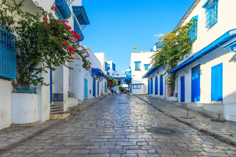 At first glance, the blue-and-white town of Sidi Bou Said, perched on a promontory overlooking the sparkling Mediterranean Sea, could easily be mistaken for a charming island village in Greece. After all, it has all the hallmarks of a Greek isle, including cobblestone streets, bright white-painted stone buildings, and myriad alfresco cafés. But the Tunisian city boasts its own unique elements that make it worth visiting. You could even spend a whole day wandering up and down Rue Habib Thameur, popping into galleries, coffee shops, and boutiques.