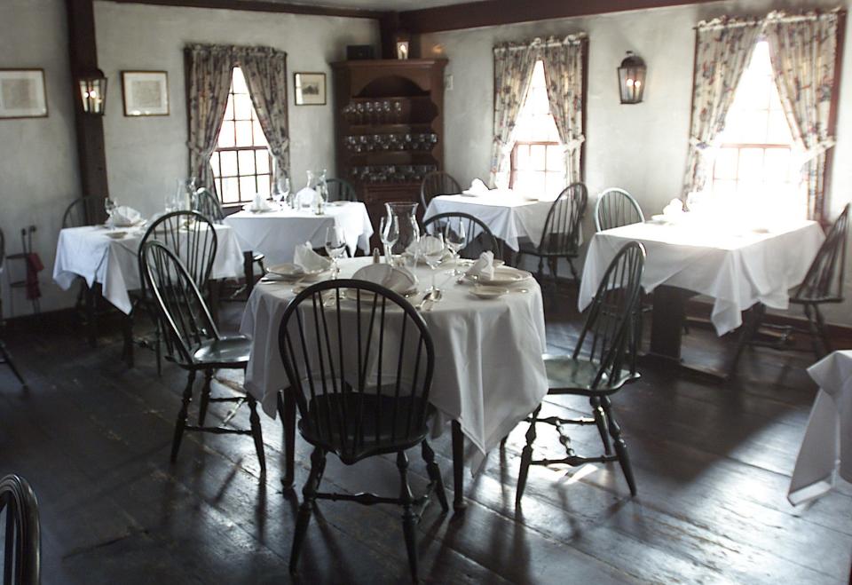 The second floor dining room of the White Horse Tavern sits empty with polished silver and glassware as the 1673 building waits for dinners in  Newport.