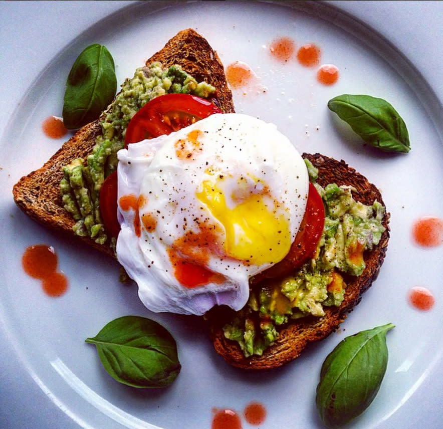 <p>Smashed avocado, tomato and poached egg on toast with basil and chilli sauce [Photo: Instagram/maryflynch] </p>