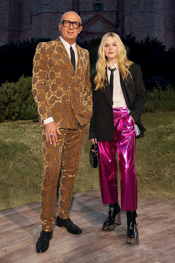 Elle Fanning and Marco Bizzarri attend Gucci’s “Cosmogonie” Resort 2023 runway show in Puglia, Italy on May 16, 2022. - Credit: Courtesy of Getty