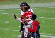 Steve McLendon #96 of the Tampa Bay Buccaneers leaves the field with his children after defeating the Kansas City Chiefs 31-9 in Super Bowl LV at Raymond James Stadium on February 07, 2021 in Tampa, Florida. (Photo by Kevin C. Cox/Getty Images)