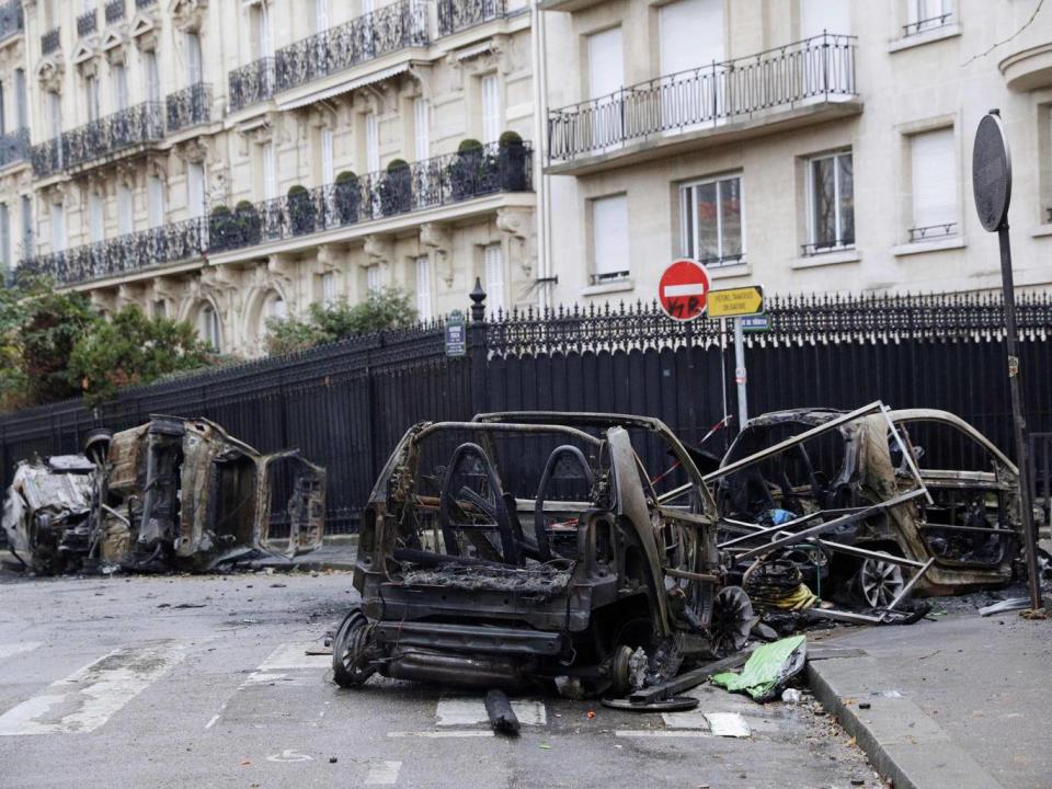 Burned cars are left behind after the clashes in Paris (AFP/Getty)