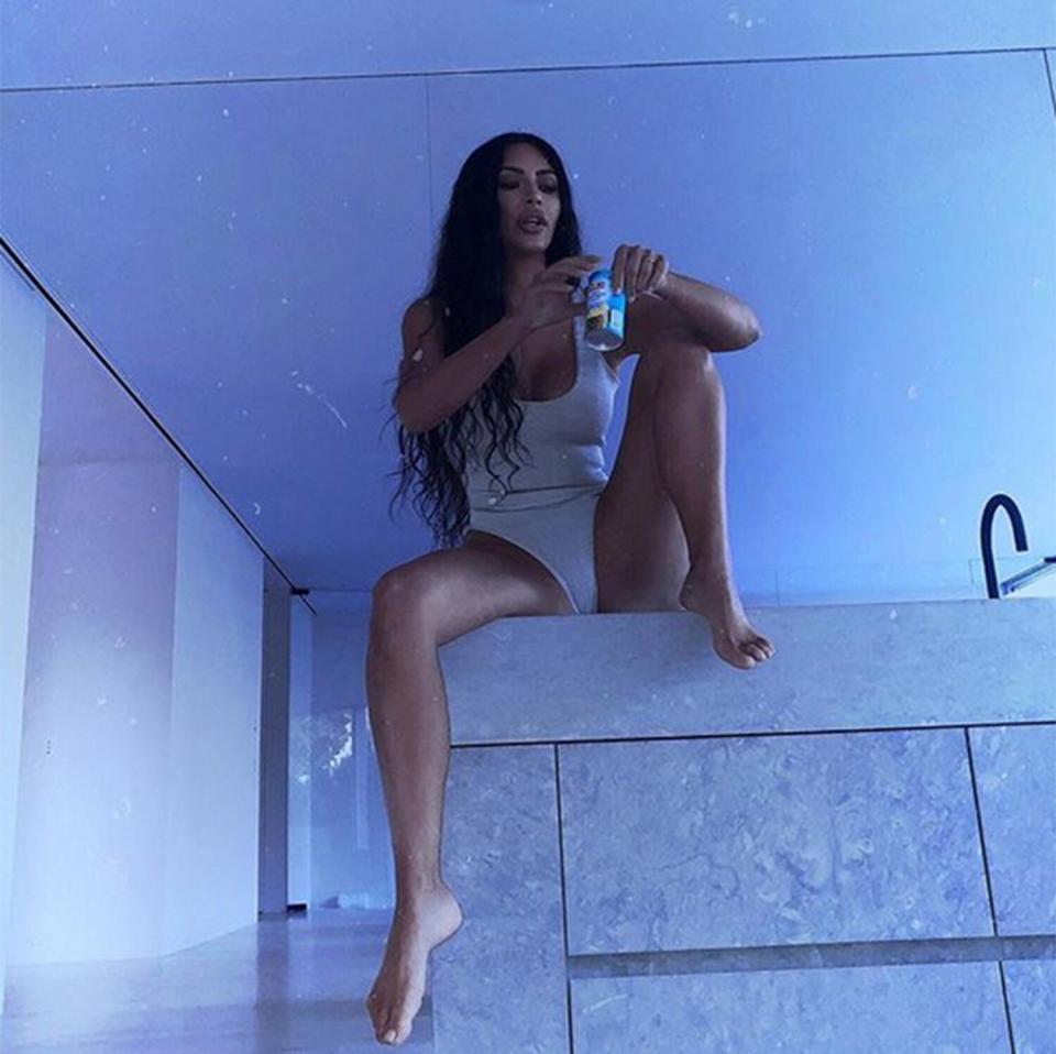 While sitting on the counter in her nearly bare bathroom, Kim opened a can of pineapple juice and challenges her followers to "google the benefits" of the citrus.