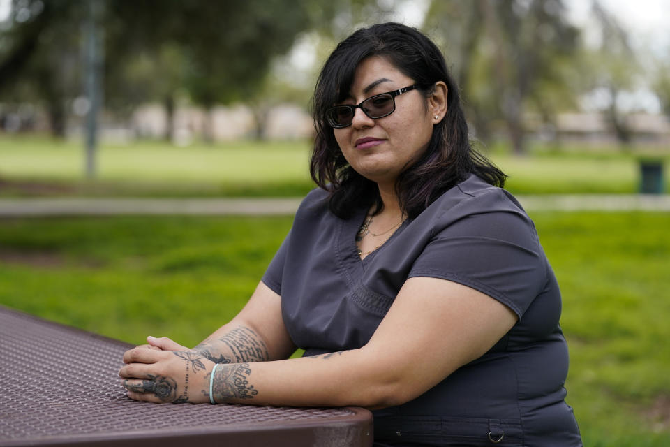 Vanessa Martinez poses for a photo on Monday, March 20, 2023, in Chandler, Ariz. Martinez was shot in the head by her ex-boyfriend in September 2021, and was denied victim compensation due to unpaid court fines from unrelated incidents. (AP Photo/Ashley Landis)