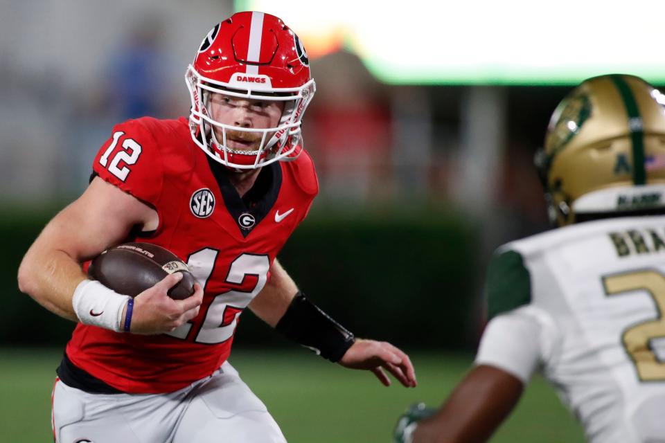 Georgia quarterback <a class="link " href="https://sports.yahoo.com/ncaaf/players/322211" data-i13n="sec:content-canvas;subsec:anchor_text;elm:context_link" data-ylk="slk:Brock Vandagriff;sec:content-canvas;subsec:anchor_text;elm:context_link;itc:0">Brock Vandagriff</a> (12) runs the ball during the second half of a NCAA college football game against <a class="link " href="https://sports.yahoo.com/ncaaf/teams/uab/" data-i13n="sec:content-canvas;subsec:anchor_text;elm:context_link" data-ylk="slk:UAB;sec:content-canvas;subsec:anchor_text;elm:context_link;itc:0">UAB</a> in Athens, Ga., on Saturday, Sept. 23, 2023.