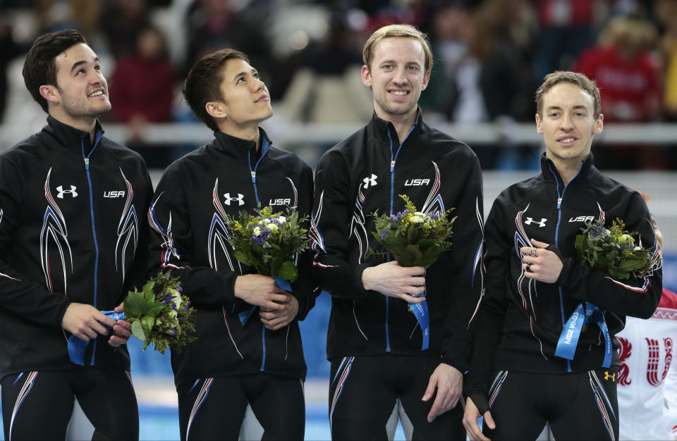 From left, Eduardo Alvarez of the United States, J.R. Celski of the United States, Chris Creveling of the United States and Jordan Malone of the United States stand on the podium after placing second during the flower ceremony for the men's 5000m short track speedskating relay final at the Iceberg Skating Palace during the 2014 Winter Olympics, Friday, Feb. 21, 2014, in Sochi, Russia. (AP Photo/Ivan Sekretarev)