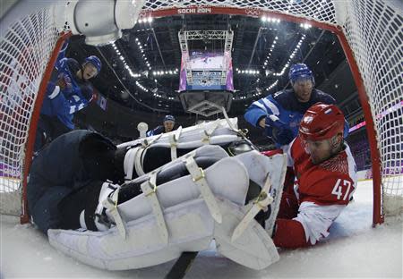 Russia's Alexander Radulov (47) falls into the Finland goal during the third period of their men's quarter-finals ice hockey game at the Sochi 2014 Winter Olympic Games February 19, 2014. REUTERS/Julio Cortez/Pool