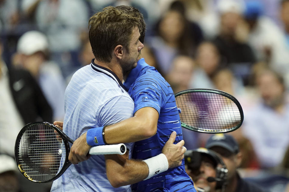 Novak Djokovic, of Serbia, right, hugs Stan Wawrinka, of Switzerland, as Djokovic retires during the U.S. Open tennis championships, Sunday, Sept. 1, 2019, in New York. (AP Photo/Eduardo Munoz Alvarez)