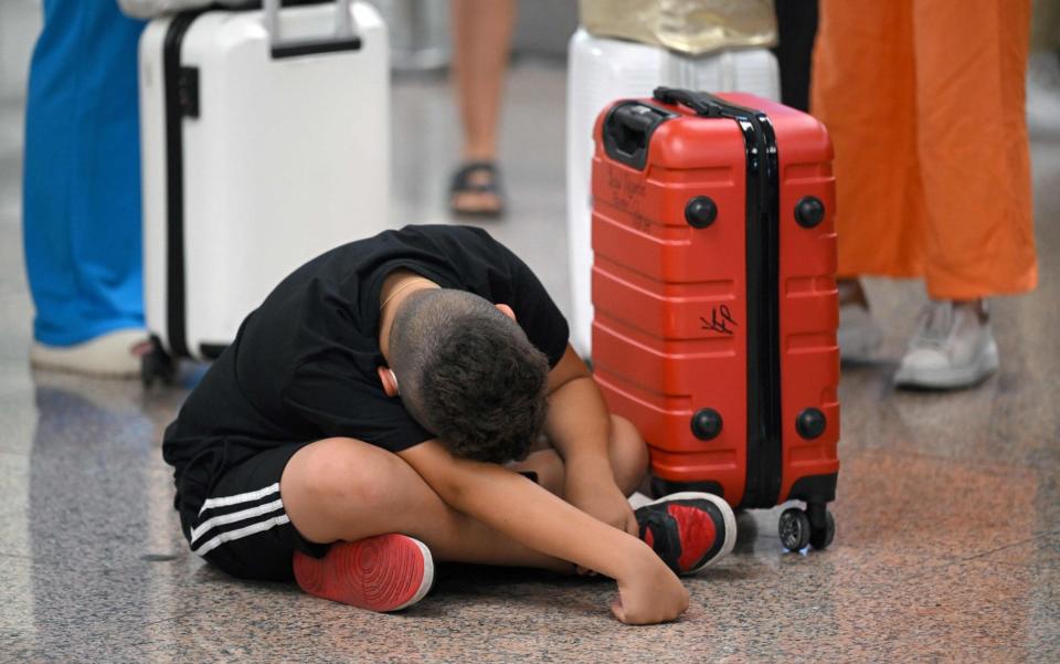 Passengers affected by strike action wait at El Prat airport, in Barcelona, on Thursday - Lluis Gene/AFP via Getty Images