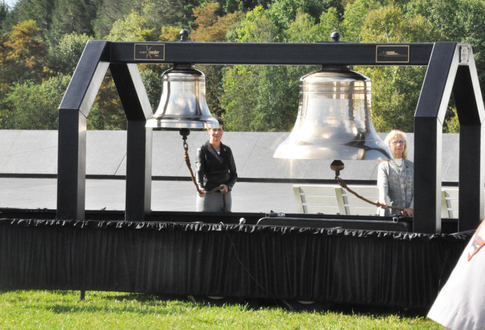Jan Loney (left), metalsmith and school memorial artist, and Joy Knepp, retired art teacher, both at Shanksville-Stonycreek School District, rang the bells of remembrance Monday, as the names of the passengers and flight crew on Flight 93 were read.