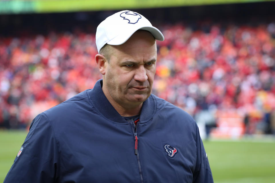 Bill O'Brien, wearing a white Texans hat, looks down before the AFC divisional playoff game last season.