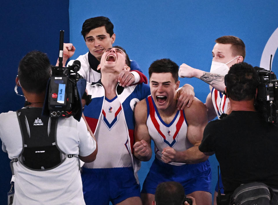 <p>The male gymnasts from Russia celebrate their artistic gymnastics gold medal win on July 26.</p>