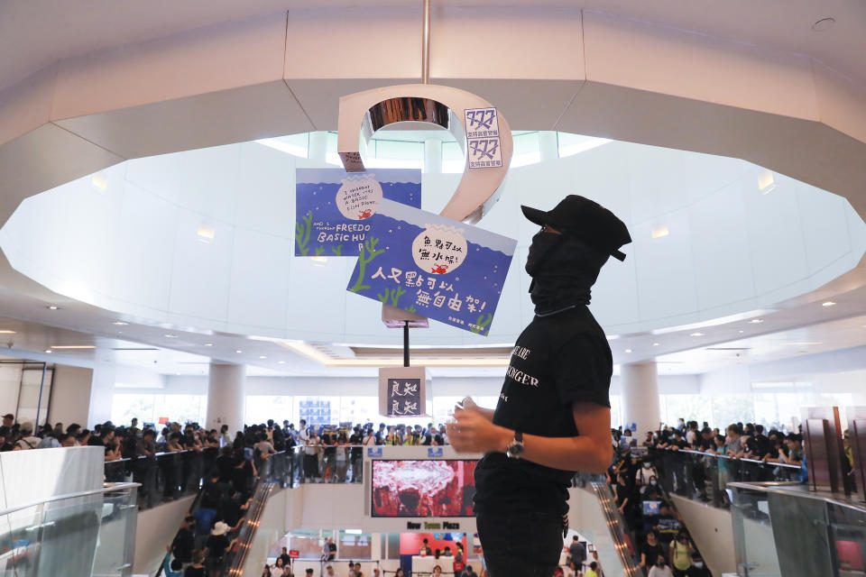 Anti-government protesters hold a rally in a shopping mall at the Sha Tin district in Hong Kong Sunday, Sept. 22, 2019. Protesters in Hong Kong burned a Chinese flag and police fired pepper spray Saturday in renewed clashes over grievances by the anti-government demonstrators. (AP Photo/Kin Cheung)