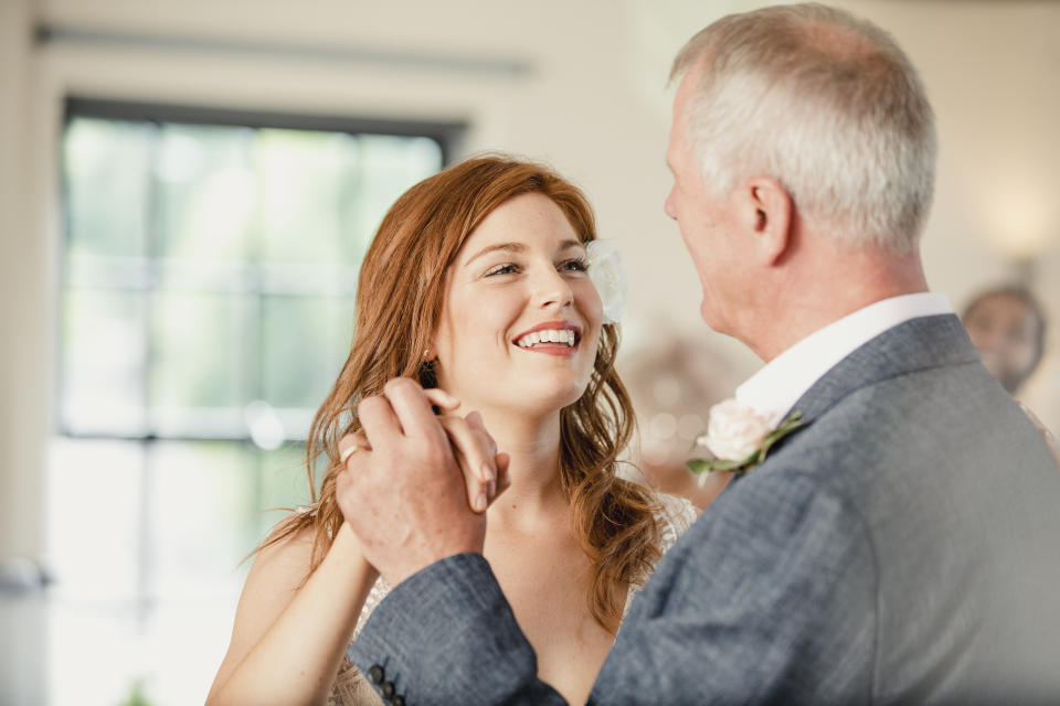 Beautiful bride is enjoying a dance with her father on her wedding day.