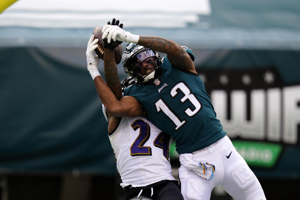 Philadelphia Eagles' Travis Fulgham (13) cannot catch a pass against Baltimore Ravens' Marcus Peters (24) during the second half of an NFL football game, Sunday, Oct. 18, 2020, in Philadelphia. (AP Photo/Chris Szagola)