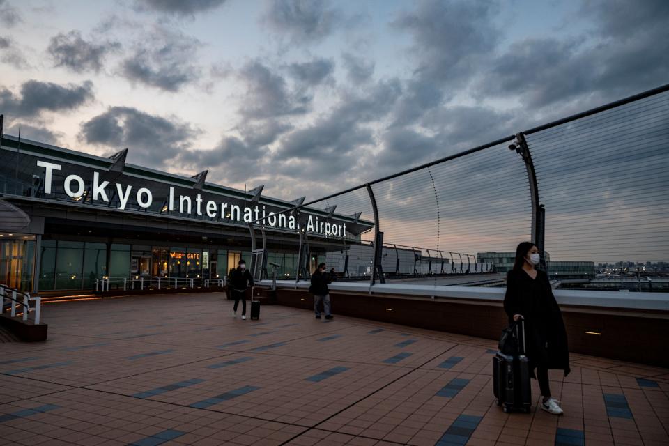 Travellers visit the observation deck at Tokyo's Haneda airport on December 27, 2020, after the government announced more restrictions on travel due to the rise of COVID-19 coronavirus infections across the country. (Photo by Philip FONG / AFP) (Photo by PHILIP FONG/AFP via Getty Images)