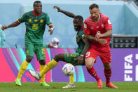 Switzerland's Haris Seferovic, right, vies for the ball with Cameroon's Nicolas Nkoulou and Tolo Nouhou during the World Cup group G soccer match between Switzerland and Cameroon, at the Al Janoub Stadium in Al Wakrah, Qatar, Thursday, Nov. 24, 2022. Switzerland won 1-0. (AP Photo/Luca Bruno)