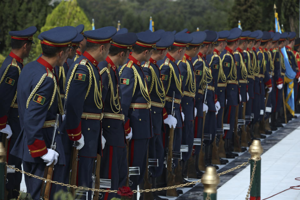 Members of the honor guard stand at attention during the Independence Day celebrations at Defense Ministry in Kabul, Afghanistan, Tuesday, Aug. 18, 2020. Several mortar shells slammed into various part of Kabul on Tuesday morning as Afghans marked their country's Independence Day amid new uncertainties over the start of talks between the Taliban and the Kabul government. (AP Photo/Rahmat Gul)