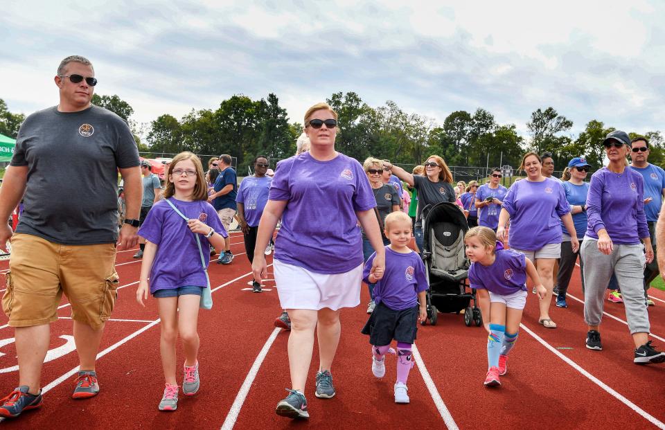 The Hatchett family works with their 4-year-old daughter Brynn, center, and her best friend Macey Mendell as they lead the walk of cancer survivors, fighters and supporters around the Giacosa Stadium in the Relay for Life fundraiser for the American Cancer Society at the Father Ryan High School in Nashville, Tenn., Saturday, Sept. 30, 2017.