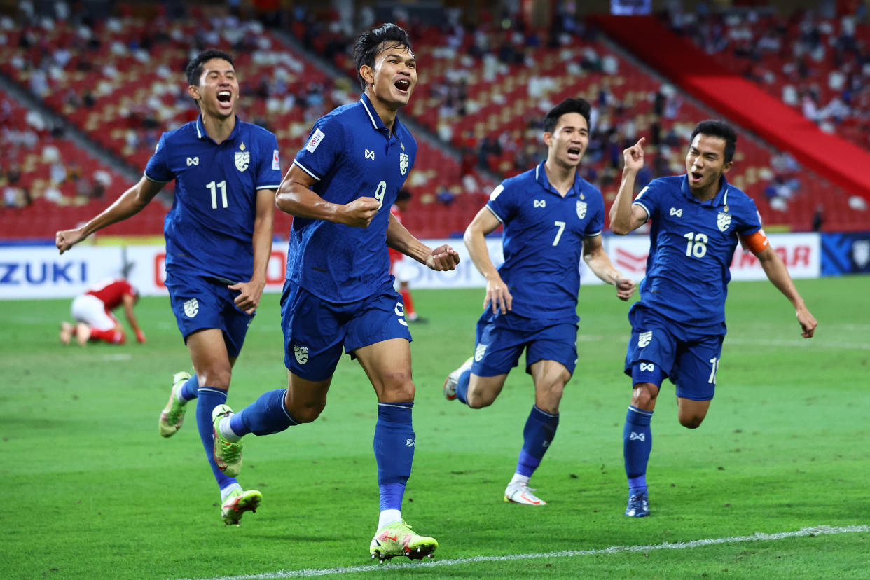 Thailand's Adisak Kraisorn (second from left) celebrates with his teammates after scoring their first goal against Indonesia in the second leg of the AFF Suzuki Cup final.