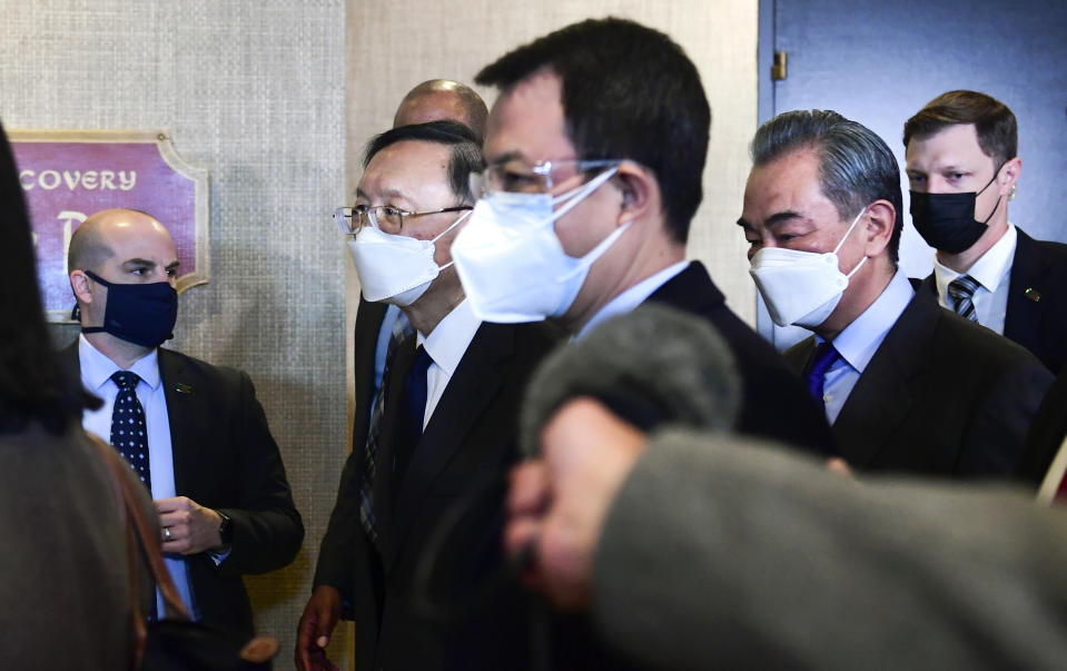 Chinese Communist Party foreign affairs chief Yang Jiechi, second from left, and China's State Councilor Wang Yi, second from right, depart the ballroom from the closed-door morning session of US-China talks in Anchorage, Alaska on Friday, March 19, 2021. (Frederic J. Brown/Pool via AP)