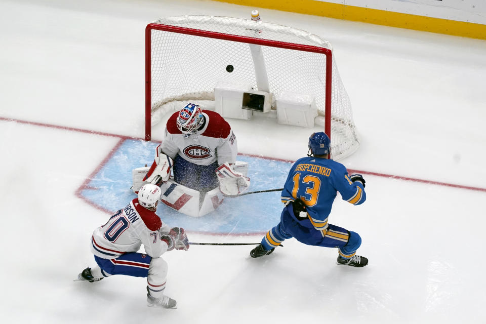 St. Louis Blues' Alexey Toropchenko (13) scores past Montreal Canadiens goaltender Sam Montembeault (35) and Tanner Pearson (70) during the third period of an NHL hockey game Saturday, Nov. 4, 2023, in St. Louis. (AP Photo/Jeff Roberson)