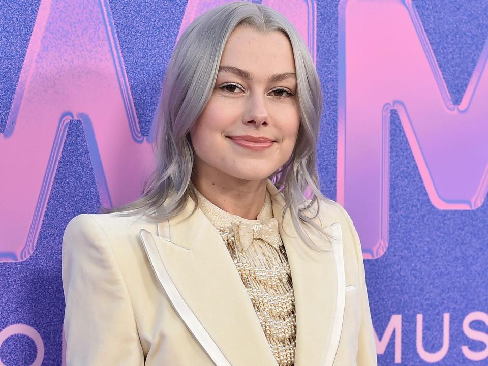 Musician Phoebe Bridgers poses at a red carpet for the 2022 Billboard Women in Music Awards.