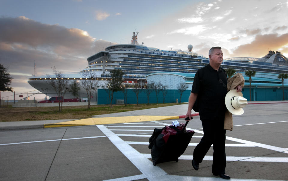 Jack Doebbler walks to his vehicle after getting off the Caribbean Princess cruise ship, Friday, Jan. 31, 2014, in La Porte, Texas. The ship returned to port early on Friday due to a dense fog advisory and not because people were vomiting and had diarrhea, a Princess Cruises spokeswoman said Friday. But passengers said the crew announced on the second day of the cruise that people were sick, apparently with highly contagious norovirus, and that extra precautions were being taken to ensure it didn’t spread. (AP Photo/Houston Chronicle, Cody Duty)