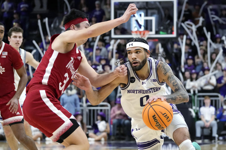 Northwestern guard Boo Buie, right, drives against Nebraska guard Keisei Tominaga during the second half of an NCAA college basketball game in Evanston, Ill., Wednesday, Feb. 7, 2024. Northwestern won 80-68. (AP Photo/Nam Y. Huh)