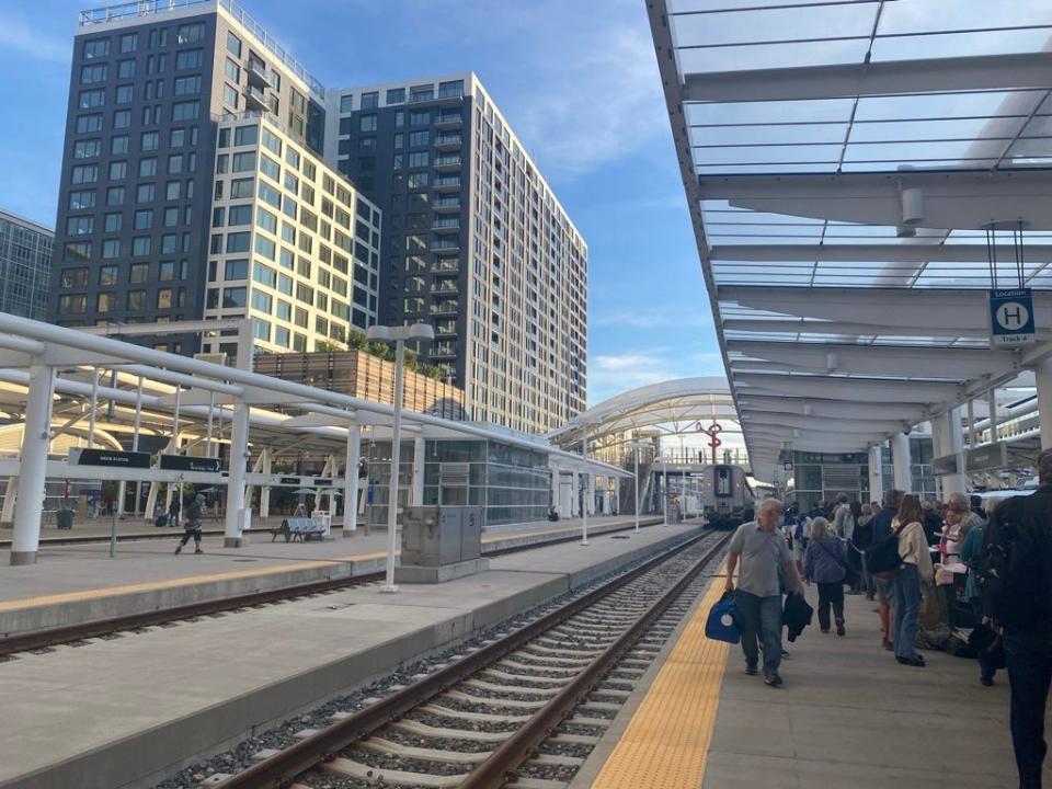 people waiting for train at train station in denver