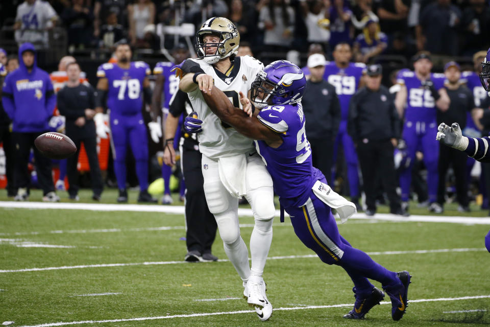 FILE - In this Sunday, Jan. 5, 2020, file photo, New Orleans Saints quarterback Drew Brees (9) fumbles as he is hit by Minnesota Vikings defensive end Danielle Hunter (99) in the second half of an NFL wild-card playoff football game in New Orleans. The Vikings have emerged from their bye week down two starting defensive ends, after a salary-dump trade of Yannick Ngakoue and a season-ending surgery for Danielle Hunter. (AP Photo/Butch Dill, File)