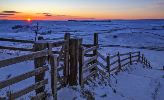 A golden hue heralds a new day over Mam Tor in the Peak District (Peter Byrne/PA)