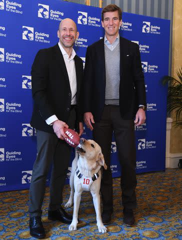 <p>Gary Gershoff/Getty Images</p> Thomas Panek, Ten and Eli Manning