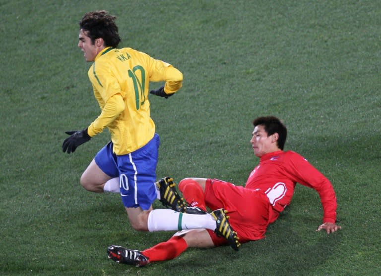 An Yong Hak challenges <a class="link " href="https://sports.yahoo.com/soccer/teams/brazil/" data-i13n="sec:content-canvas;subsec:anchor_text;elm:context_link" data-ylk="slk:Brazil;sec:content-canvas;subsec:anchor_text;elm:context_link;itc:0">Brazil</a>'s Kaka at the 2010 World Cup (VALERY HACHE)