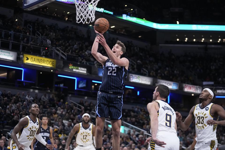 Orlando Magic's Franz Wagner (22) shoots against Indiana Pacers' T.J. McConnell (9) during the first half of an NBA basketball game, Monday, Nov. 21, 2022, in Indianapolis. AP Photo/Darron Cummings)