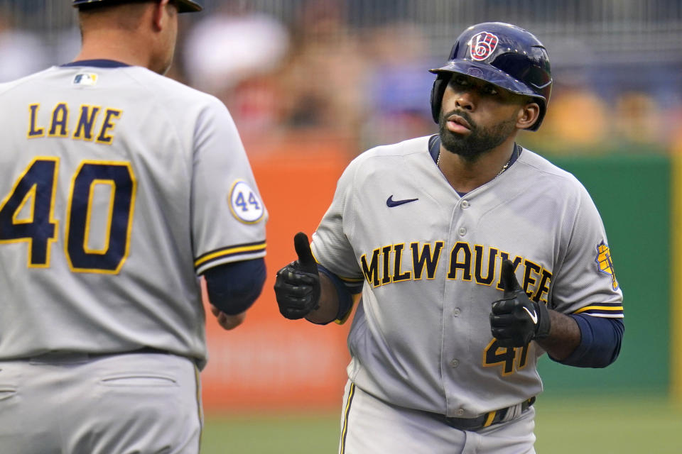 Milwaukee Brewers' Jackie Bradley Jr., right, rounds third to greetings from coach Jason Lane (40) after hitting a solo home run off Pittsburgh Pirates starting pitcher JT Brubaker during the second inning of a baseball game in Pittsburgh, Friday, July 2, 2021. (AP Photo/Gene J. Puskar)