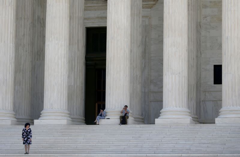 FILE PHOTO: People are pictured on the stairs outside of the U.S. Supreme Court in Washington