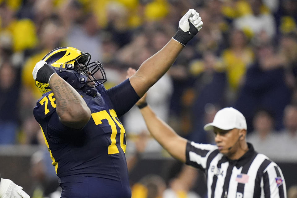 Michigan defensive lineman Kenneth Grant celebrates after sacking Washington quarterback Michael Penix Jr. during the first half of the national championship NCAA College Football Playoff game Monday, Jan. 8, 2024, in Houston. (AP Photo/Eric Gay)