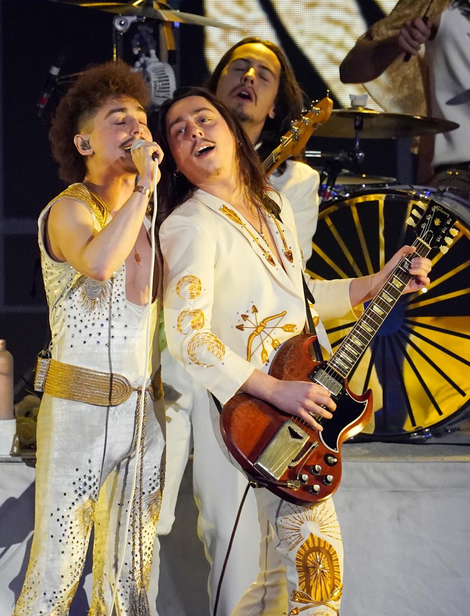 From left, Josh Kiszka, Jake Kiszka and Sam Kiszka of Greta Van Fleet perform at "Metallica Presents: The Helping Hands Concert," Friday, Dec. 16, 2022, at Microsoft Theater in Los Angeles. (AP Photo/Chris Pizzello)