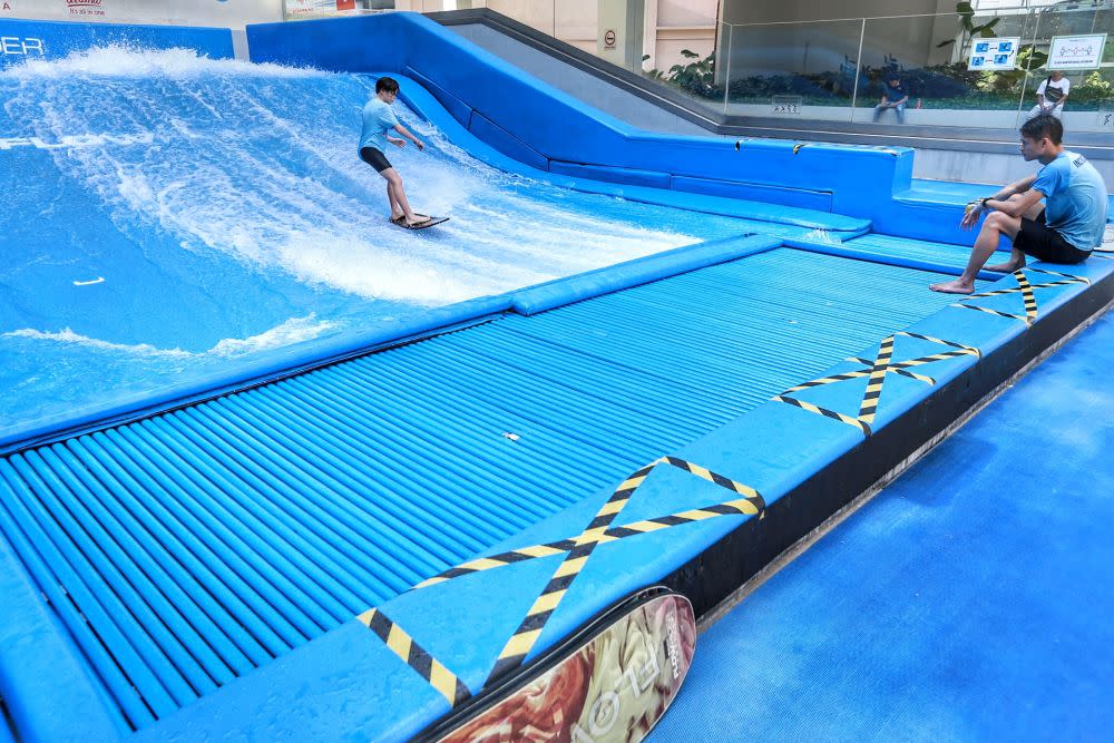 A surfer rides a wave at FlowRider, an indoor water surfing park in One Utama, Petaling Jaya July 1, 2020. — Picture by Ahmad Zamzahuri