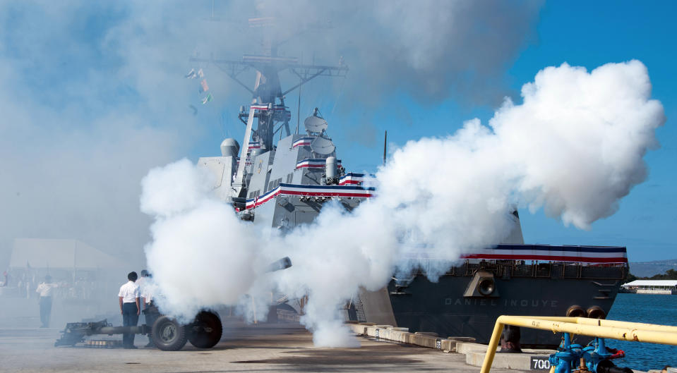 A gun salute is performed by Army Bravo Battery 2-11 Field Artillery, from Schofield Barracks, Hawaii, during the commissioning ceremony for the USS Daniel Inouye, named after the long-serving U.S. senator from Hawaii and decorated World War II veteran, at Pearl Harbor, Hawaii, Wednesday, Dec. 8, 2021. (Craig T. Kojima/Honolulu Star-Advertiser via AP)