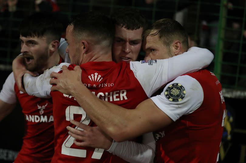 A picture of Larne players celebrating the late winner against Glentoran